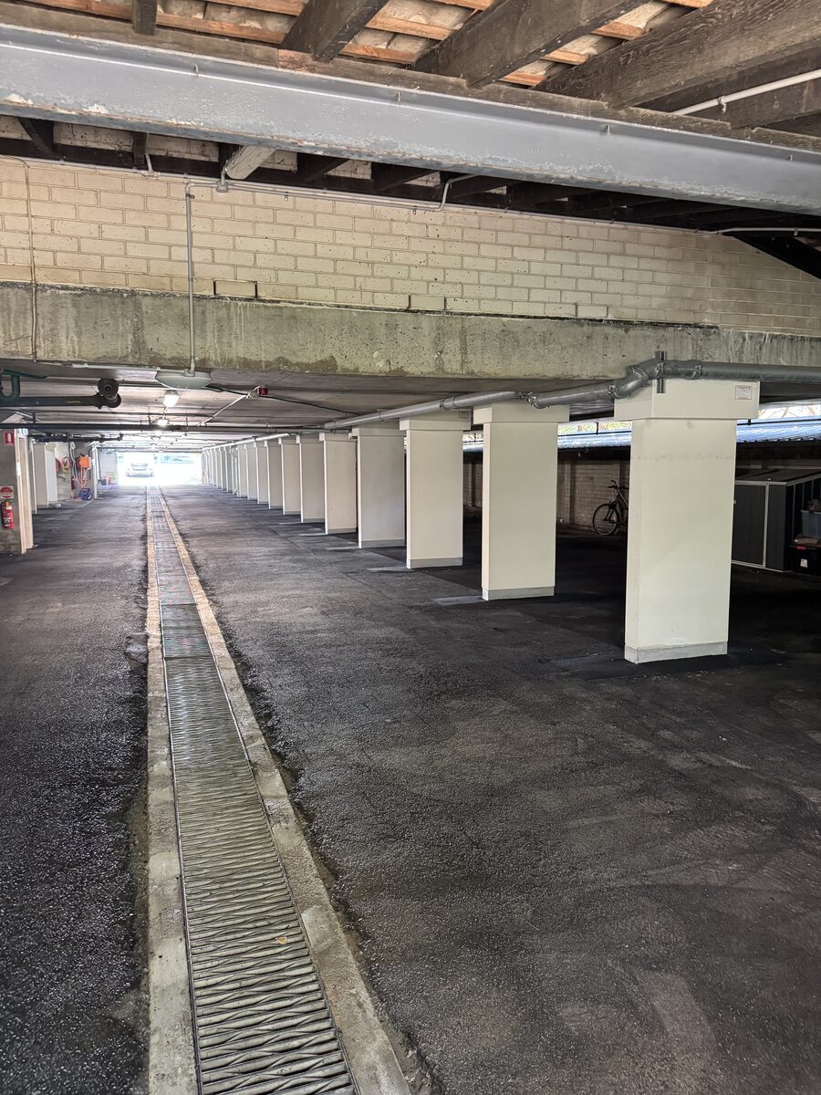 Structural steel protection — finished Trafalgar Corex column box-outs and new drainage channel in a Sydney basement car park after remedial works